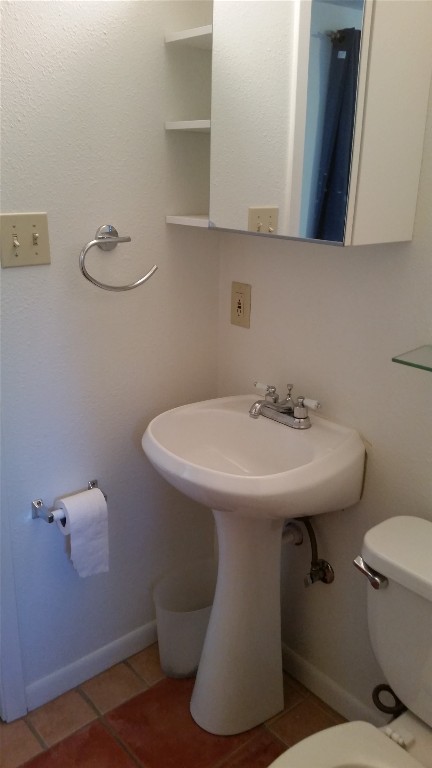 2307 B Riverside Farms Road Austin, TX 78741 - Photo 26 of 34 Bathroom featuring tile floors, toilet, a sink, and shower