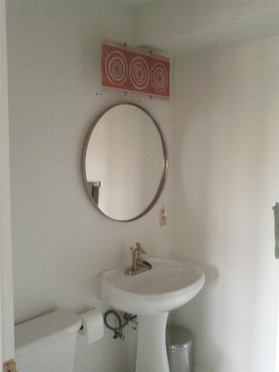 2307 B Riverside Farms Road Austin, TX 78741 - Photo 27 of 34 1/2 Bathroom featuring toilet and a sink with washer and dryer