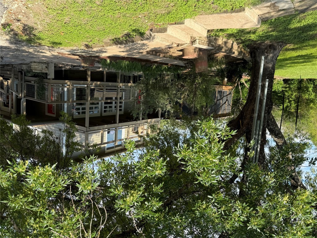 2307 B Riverside Farms Road Austin, TX 78741 - Photo 31 of 34 View of front of house featuring a front yard and a balcony