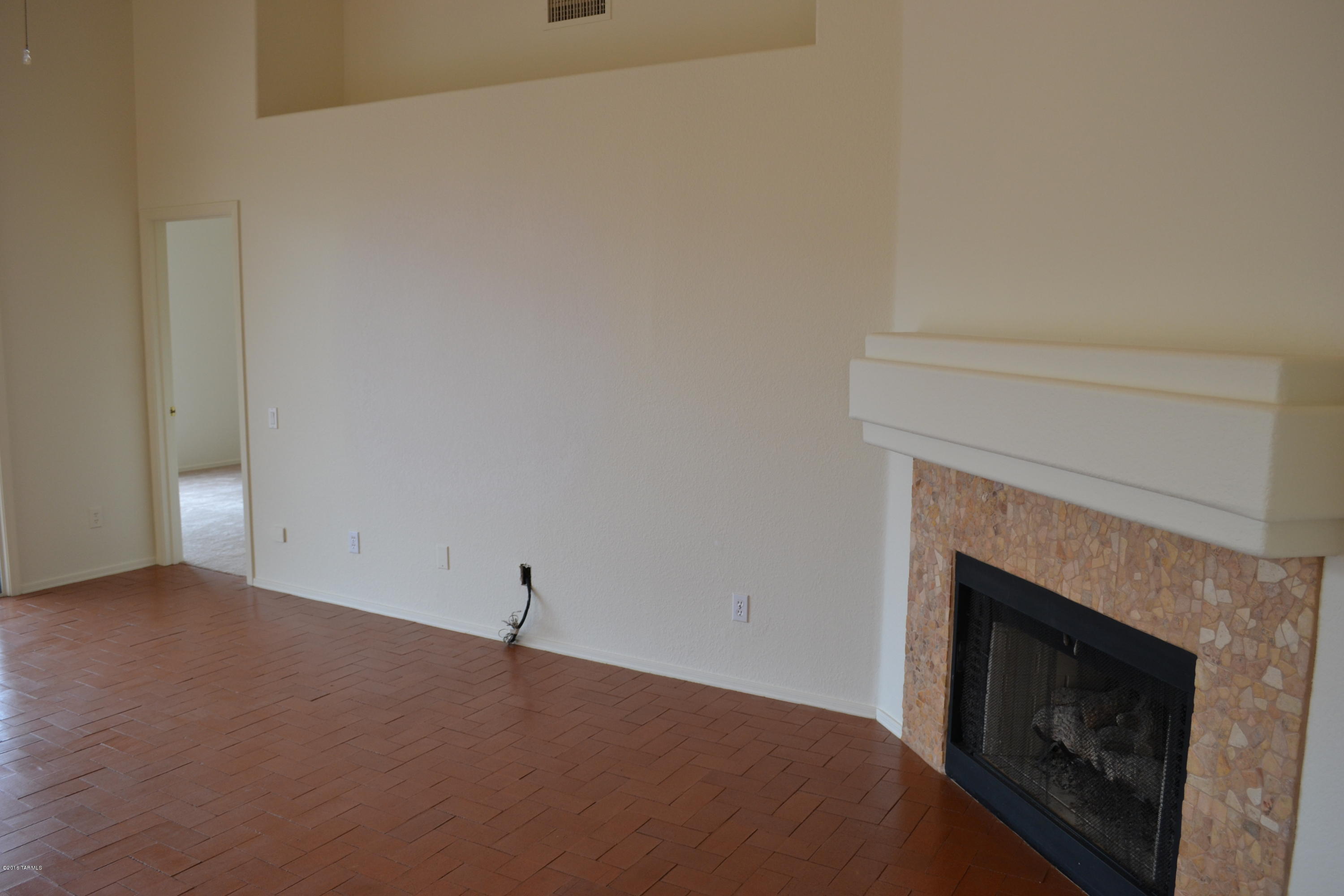5640 North Cherokee Ridge Road Tucson, AZ 85750 - Photo 13 of 39 a view of a livingroom with a fireplace
