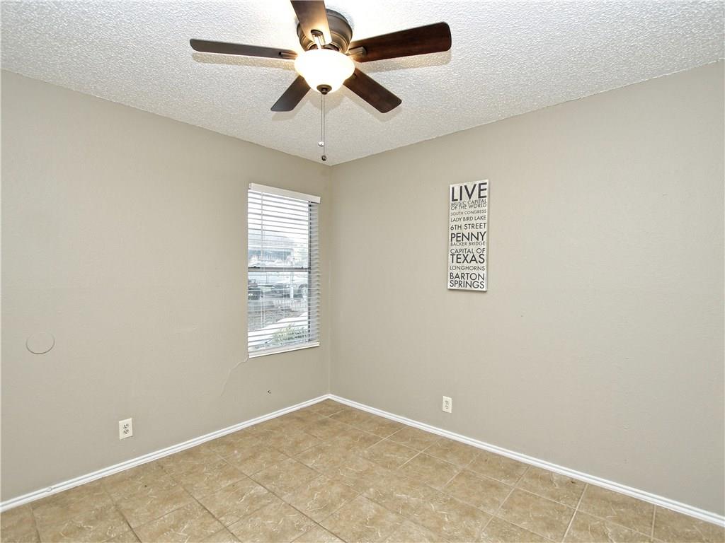 5401 Spring Meadow Road, Unit B Austin, TX 78744 - Photo 14 of 21 A well-lit room showcasing a window with blinds, perfect for a peaceful bedroom retreat.