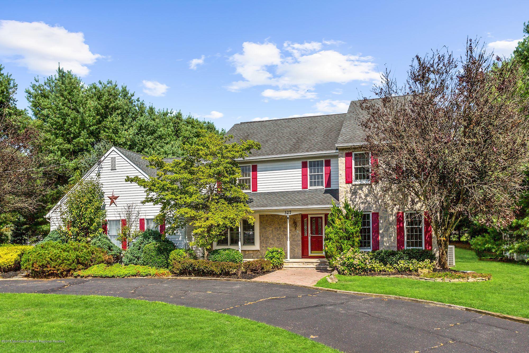 327 Buckalew Road Freehold, NJ 07728 - Photo 1 of 3 a front view of a multi story residential apartment building with yard and green space