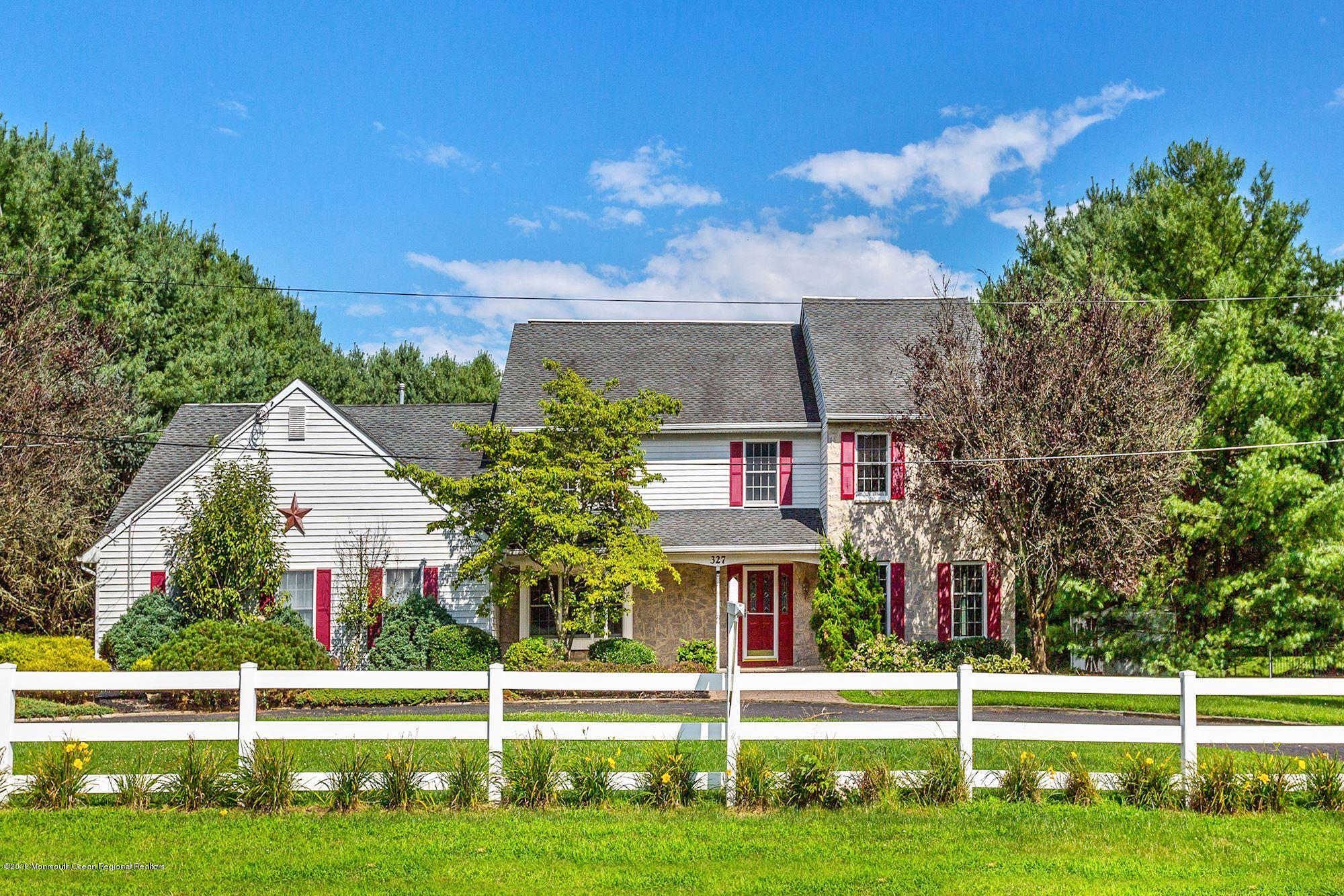 327 Buckalew Road Freehold, NJ 07728 - Photo 2 of 3 a view of a white house with a big yard and potted plants