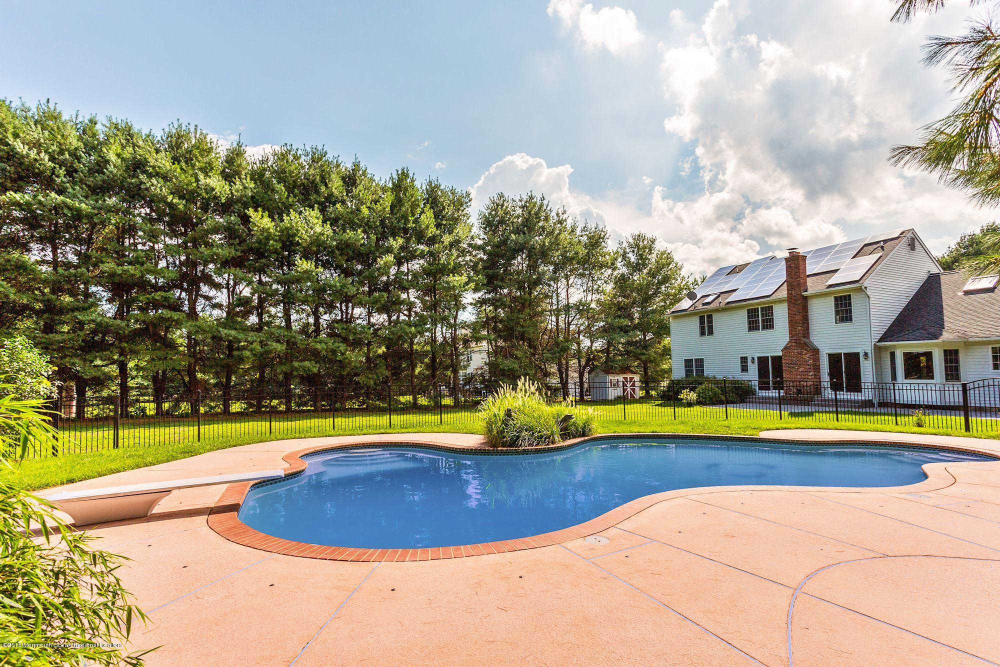 327 Buckalew Road Freehold, NJ 07728 - Photo 3 of 3 a view of a swimming pool with an outdoor space and seating area