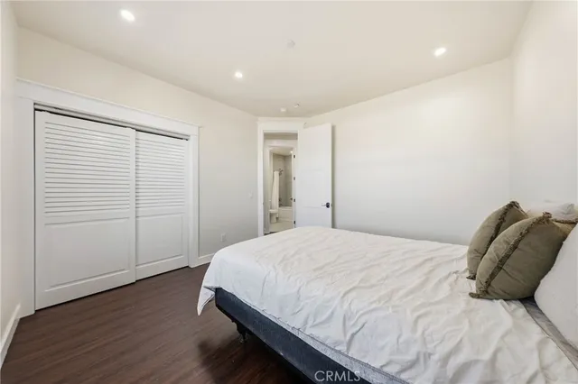 a bathroom with a toilet a sink a mirror a bathtub and vanity