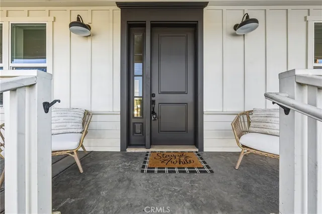 a living room with table chairs and windows