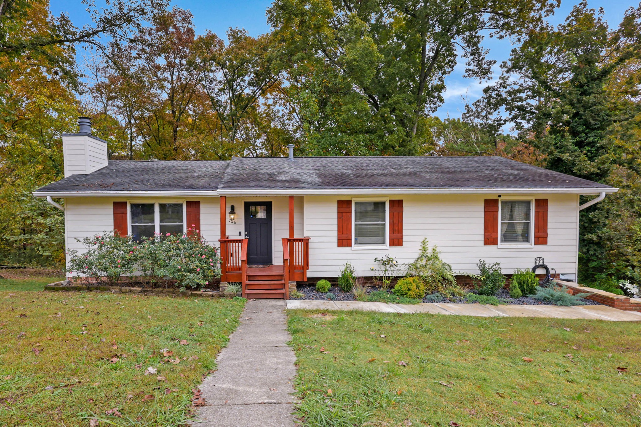 a front view of a house with a yard and porch