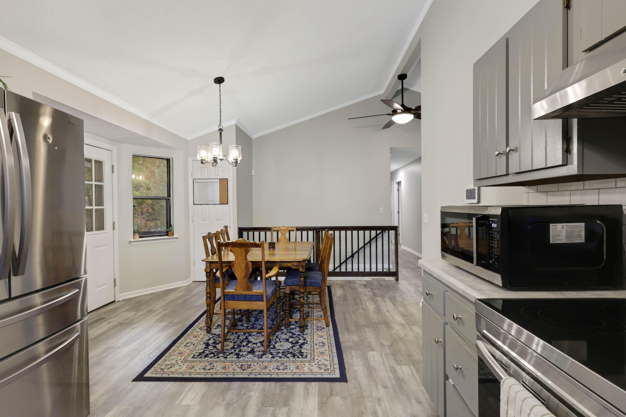 706 Swansons Ridge Road Chattanooga, TN 37421 - Photo 10 of 29 a dining room with wooden floor a chandelier a wooden table and chairs