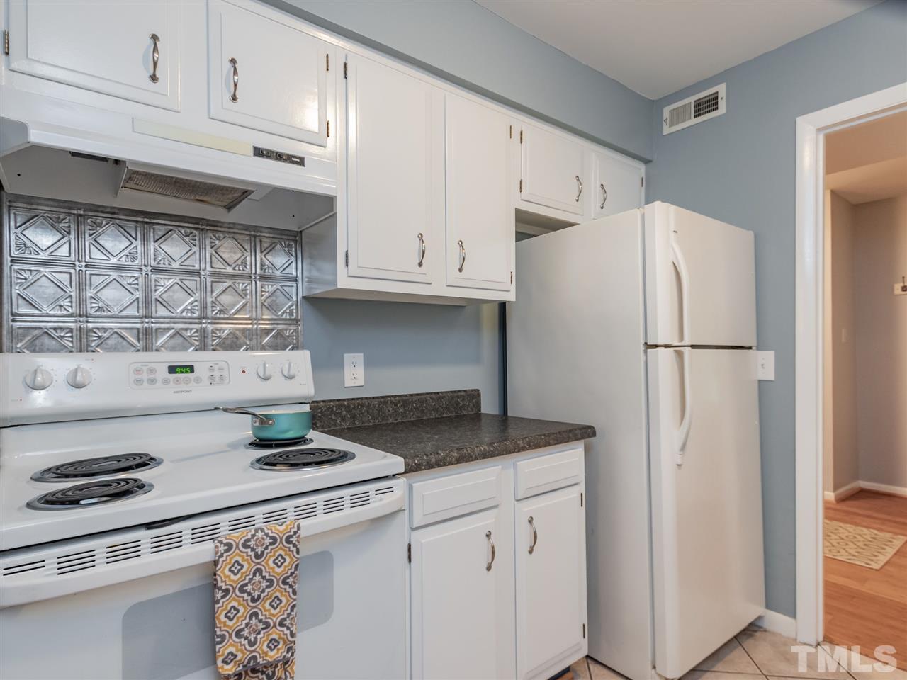 3086 Colony Road, Unit B Durham, NC 27705 - Photo 11 of 27 a kitchen with stainless steel appliances granite countertop a refrigerator sink and white cabinets