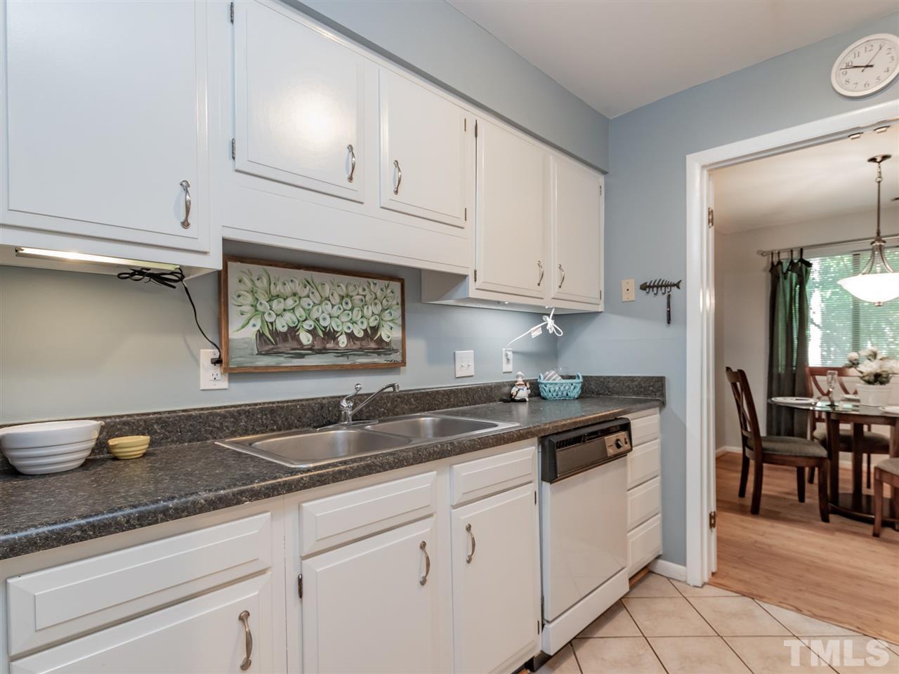 3086 Colony Road, Unit B Durham, NC 27705 - Photo 12 of 27 a kitchen with granite countertop white cabinets and white appliances