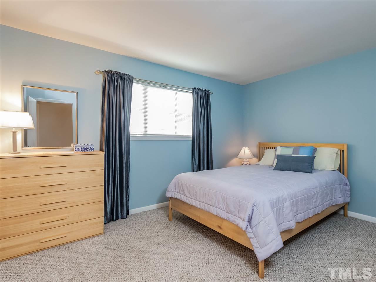 3086 Colony Road, Unit B Durham, NC 27705 - Photo 14 of 27 a bedroom with a bed and a mirror