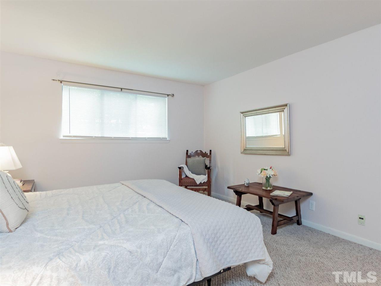 3086 Colony Road, Unit B Durham, NC 27705 - Photo 17 of 27 a bedroom with a bed a table and chair