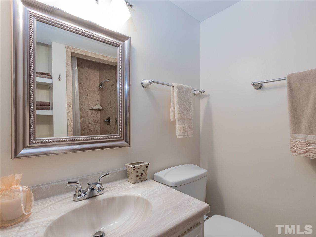 3086 Colony Road, Unit B Durham, NC 27705 - Photo 18 of 27 a bathroom with a sink mirror and a toilet