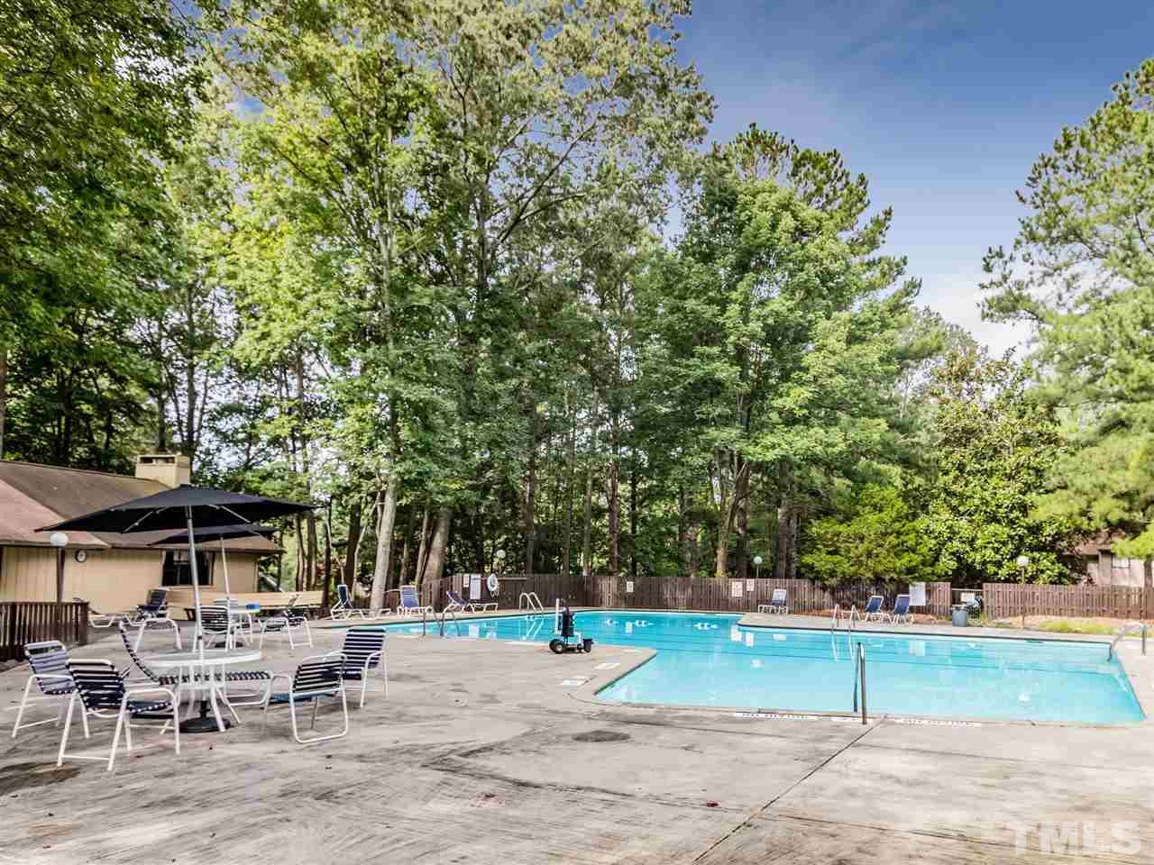 3086 Colony Road, Unit B Durham, NC 27705 - Photo 24 of 27 a view of a backyard with table and chairs under an umbrella