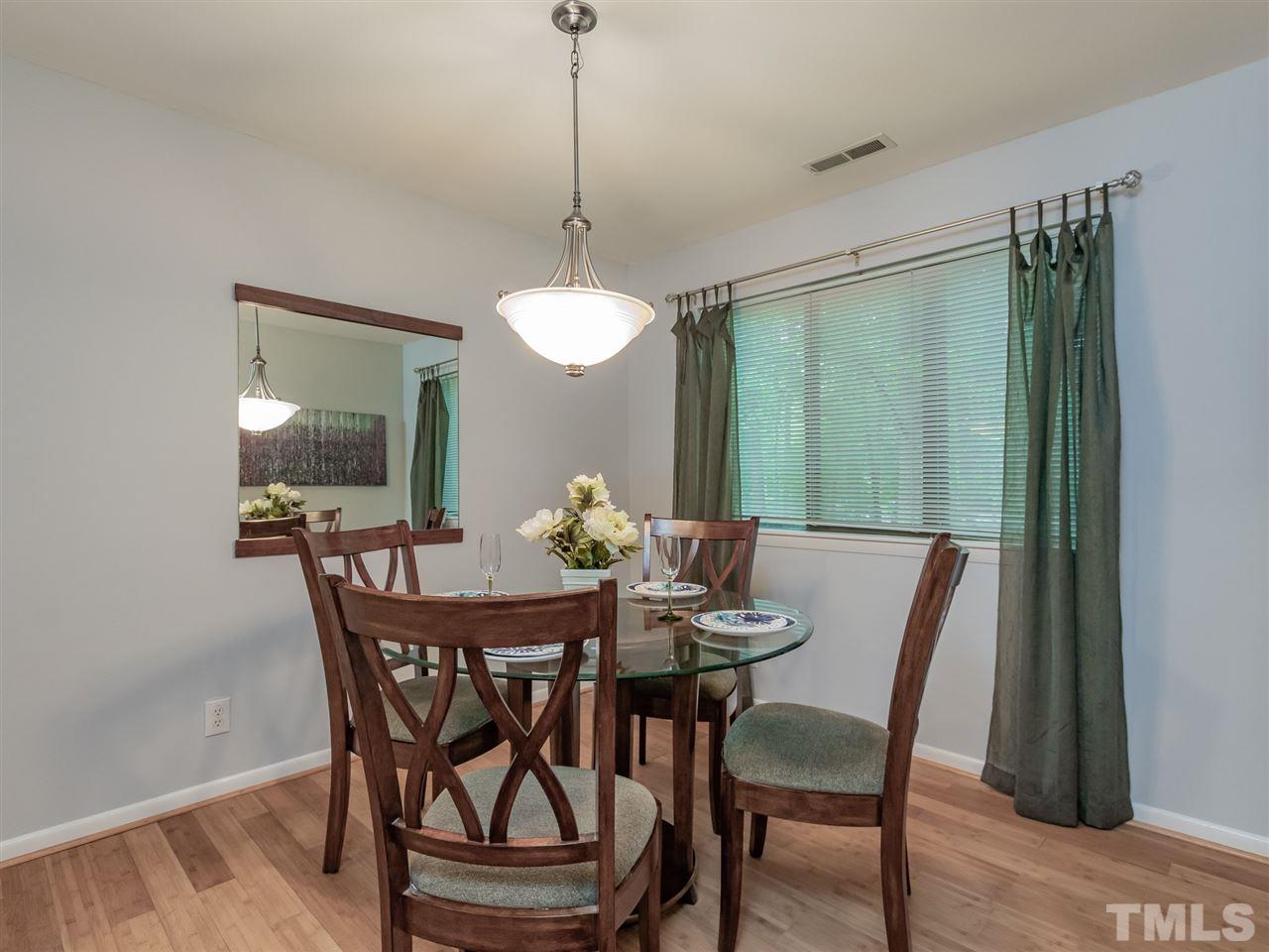 3086 Colony Road, Unit B Durham, NC 27705 - Photo 9 of 27 a view of a dining room with furniture window and wooden floor