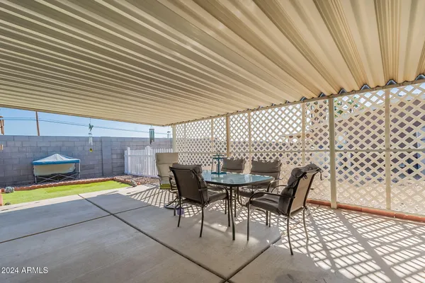 a view of a patio with table and chairs with wooden floor