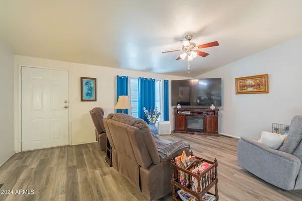 a living room with furniture and kitchen view