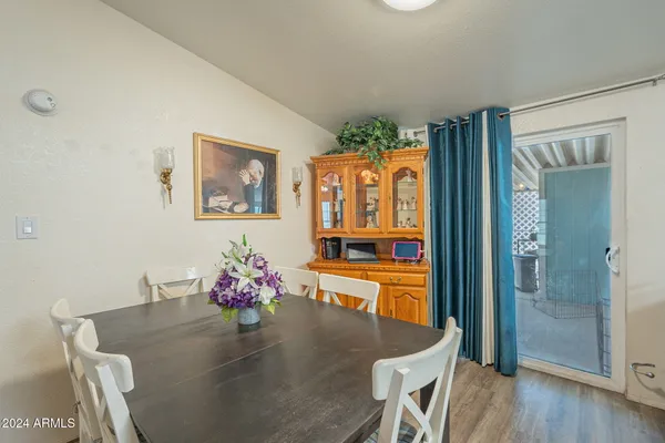 a dining room with furniture and wooden floor
