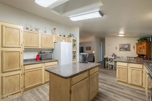 a kitchen that has cabinets a sink and appliances