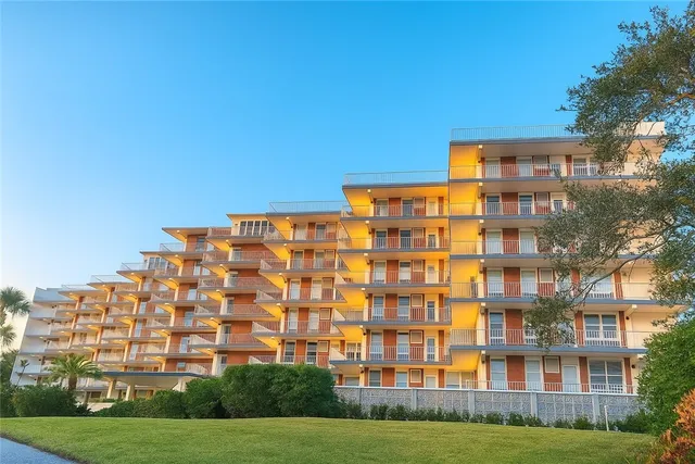 a view of a big building with a yard