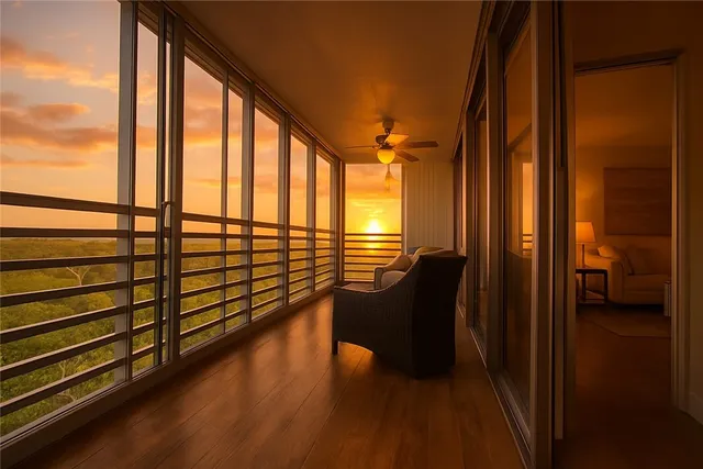 a view of a balcony with chair and floor to ceiling window