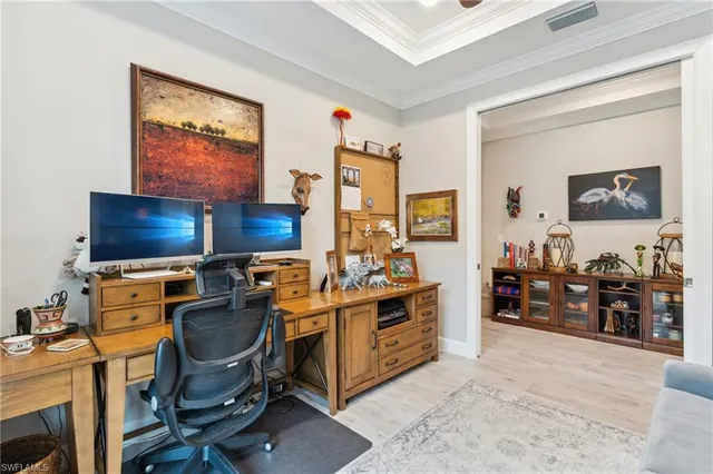 a view of a workspace with furniture and a flat screen tv