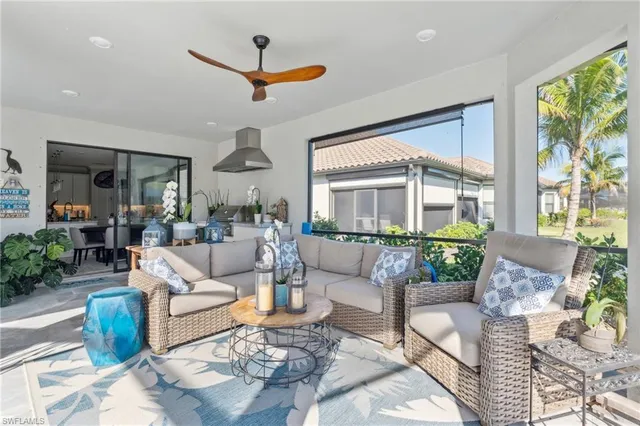 a living room with furniture a chandelier and a large window