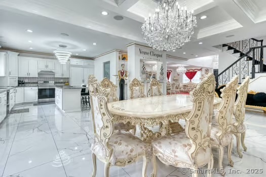 93 South Road Farmington, CT 06032 - Photo 12 of 40 a kitchen with stainless steel appliances kitchen island granite countertop a table and chairs in it