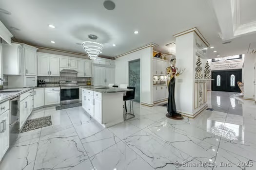 93 South Road Farmington, CT 06032 - Photo 13 of 40 a kitchen with stainless steel appliances granite countertop a refrigerator and a stove top oven