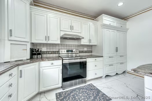 93 South Road Farmington, CT 06032 - Photo 20 of 40 a kitchen with granite countertop white cabinets and white appliances