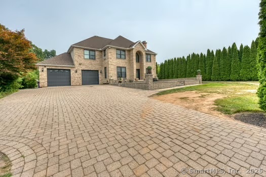 93 South Road Farmington, CT 06032 - Photo 2 of 40 a front view of a house with a yard and trees