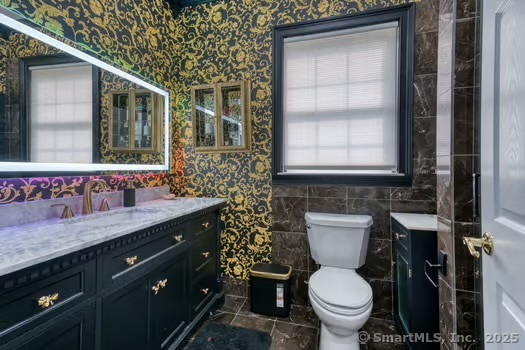 93 South Road Farmington, CT 06032 - Photo 32 of 40 a bathroom with a toilet sink and mirror