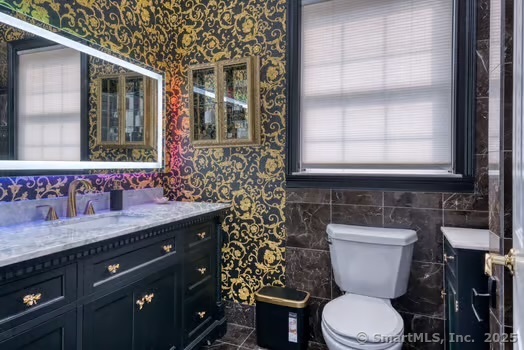 93 South Road Farmington, CT 06032 - Photo 33 of 40 a bathroom with a granite countertop toilet a sink and a window