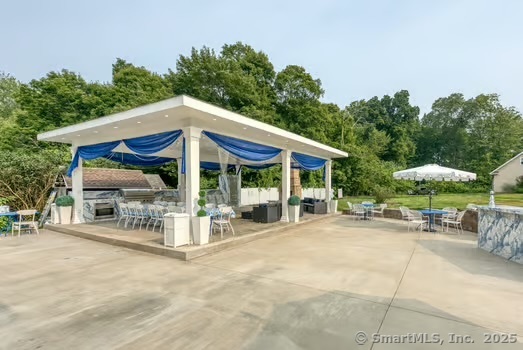 93 South Road Farmington, CT 06032 - Photo 35 of 40 a glass top table and chairs under an umbrella