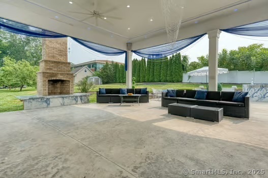 93 South Road Farmington, CT 06032 - Photo 40 of 40 a living room with patio furniture and a fireplace