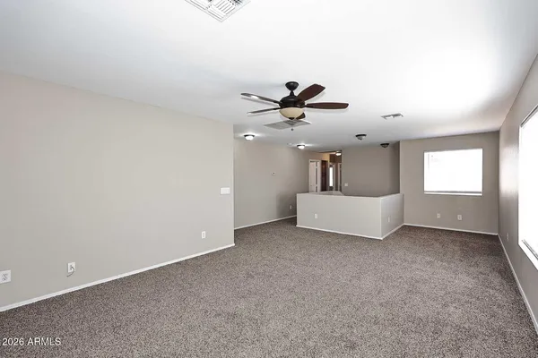 a view of a livingroom with a ceiling fan and wooden floor