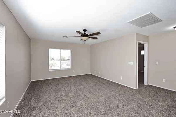 a view of a livingroom with a ceiling fan and window