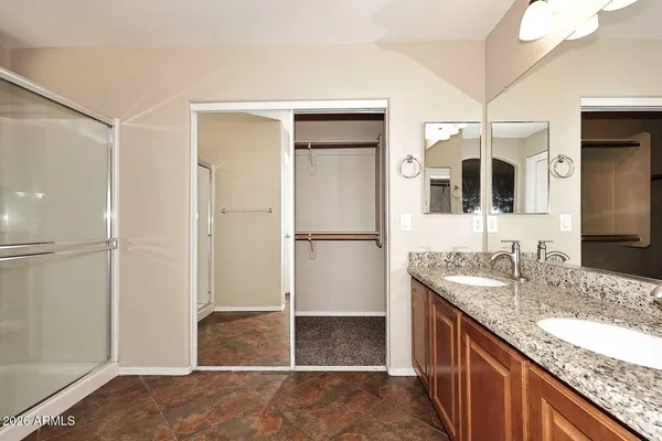 a bathroom with a granite countertop sink mirror and shower