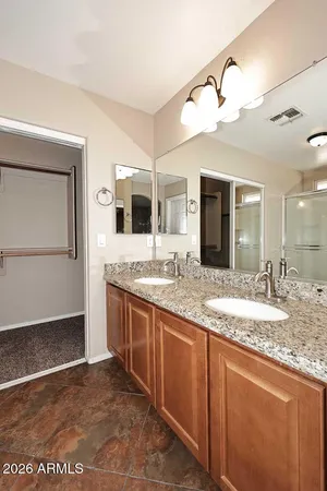 a bathroom with a granite countertop sink and mirror