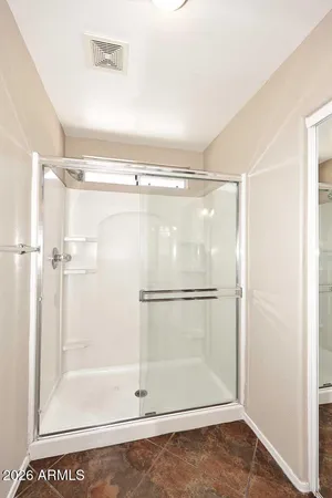 a bathroom with a glass shower door