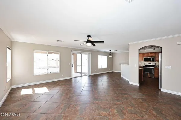an empty room with windows and cabinet