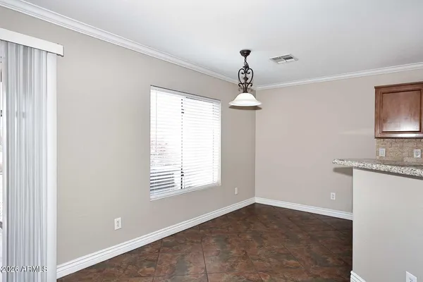 an empty room with windows and cabinet