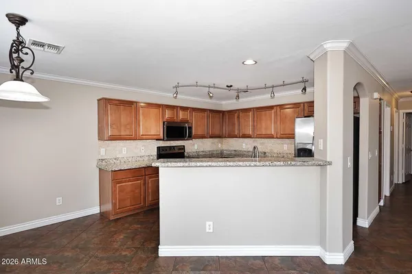 a kitchen with stainless steel appliances a refrigerator and a stove