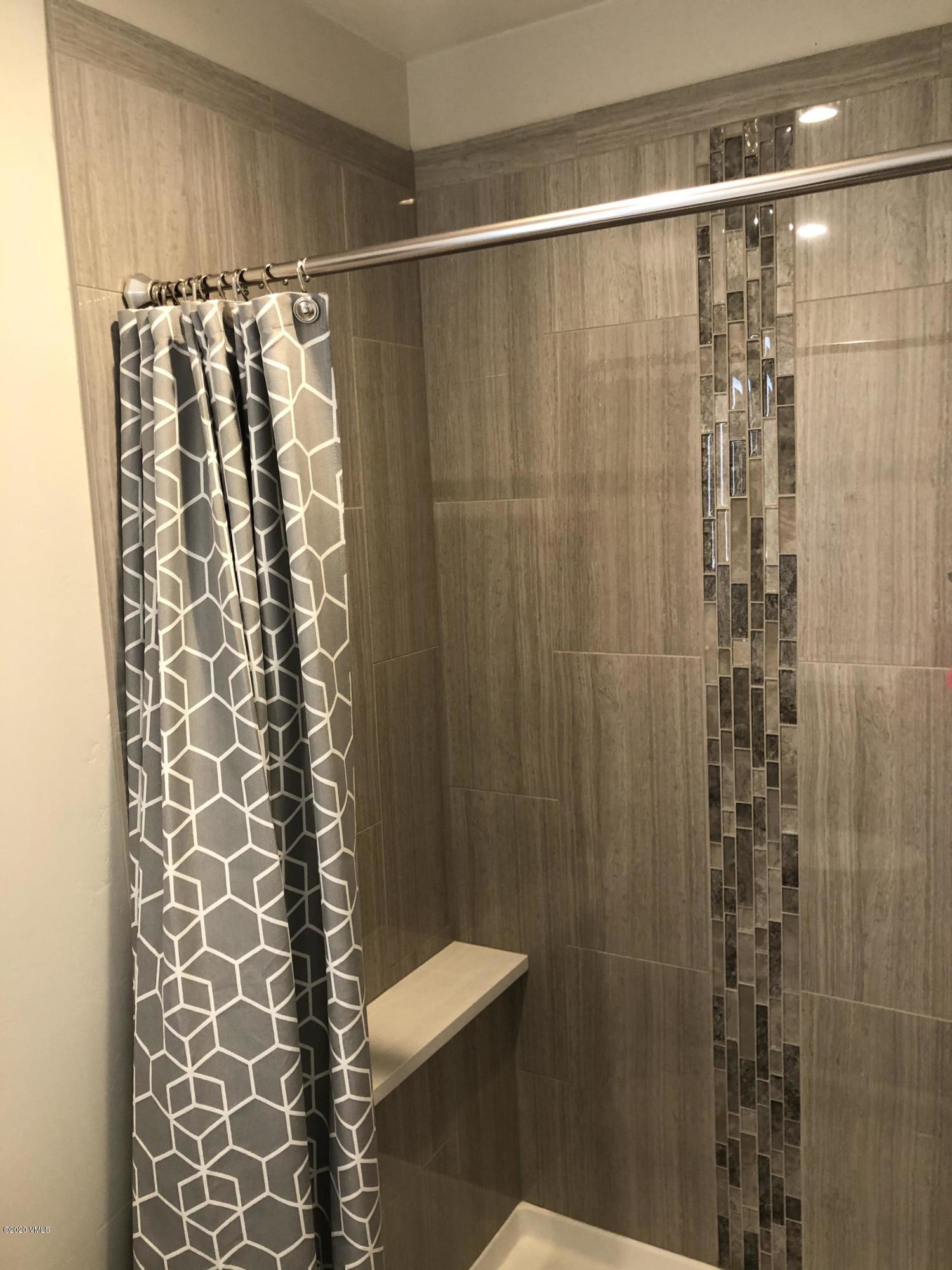 316 Wall Street, Unit 6 Eagle, CO 81631 - Photo 17 of 30 a bathroom with a shower curtain and a sink