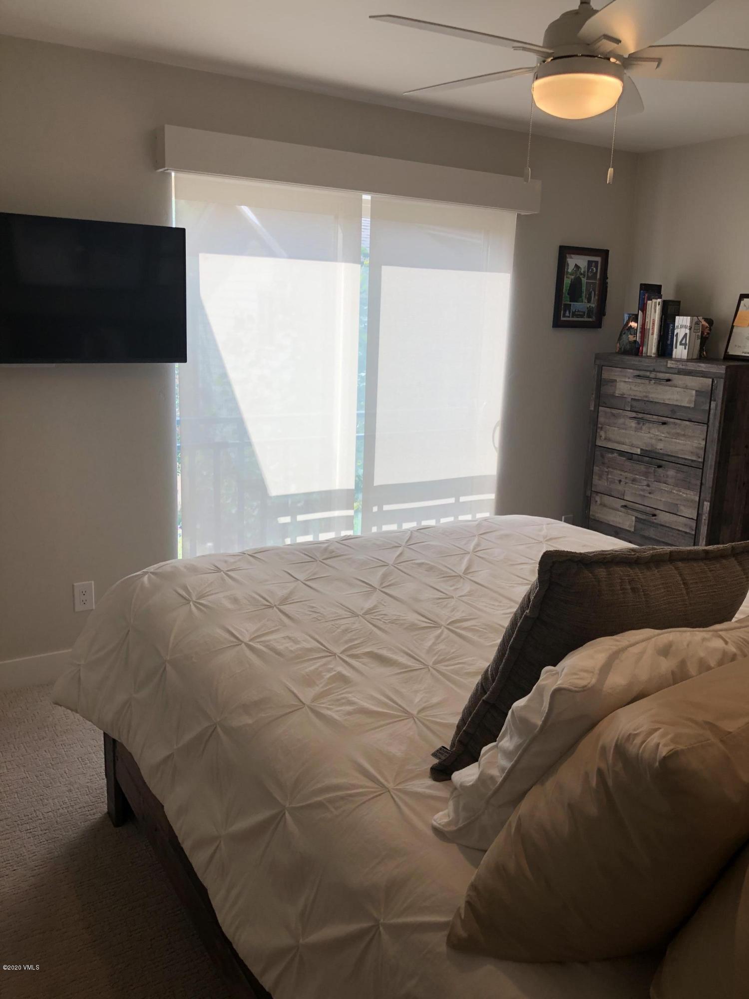 316 Wall Street, Unit 6 Eagle, CO 81631 - Photo 19 of 30 a bedroom with a bed and painting on the wall