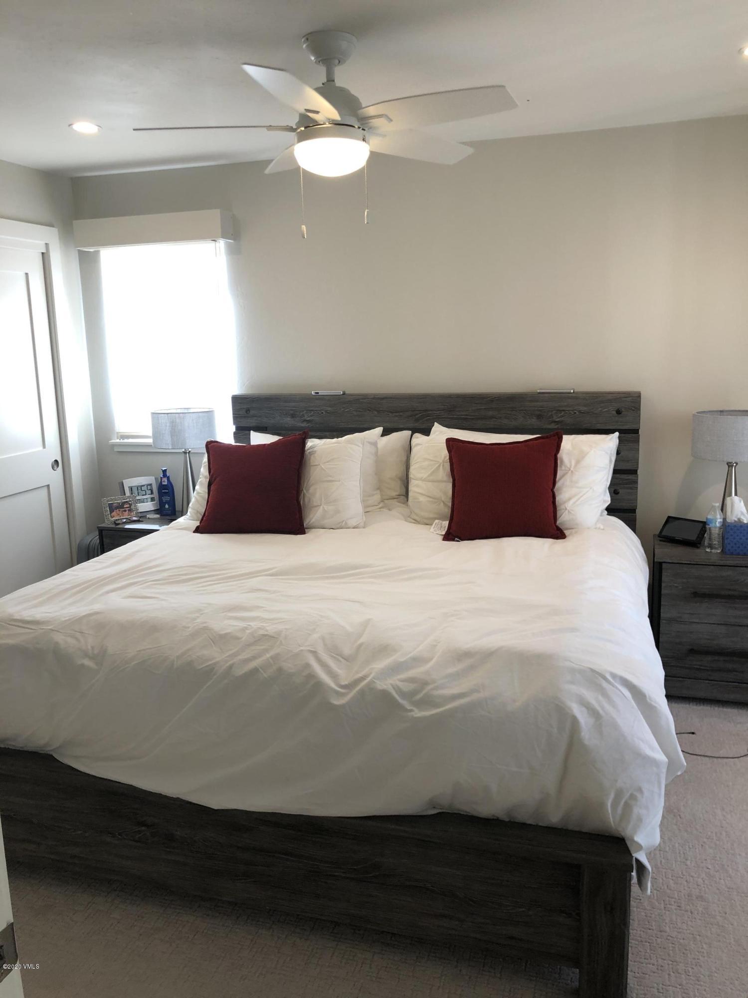 316 Wall Street, Unit 6 Eagle, CO 81631 - Photo 20 of 30 a bedroom with a bed and a chandelier