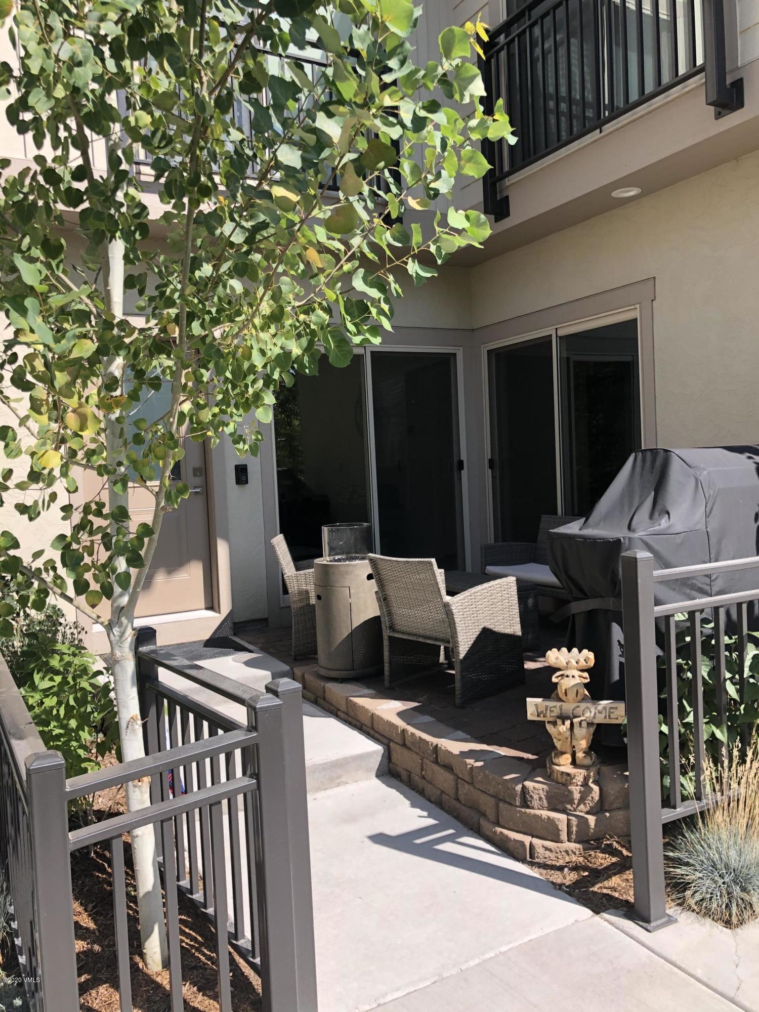 316 Wall Street, Unit 6 Eagle, CO 81631 - Photo 4 of 30 a view of a patio with table and chairs with wooden fence and plants