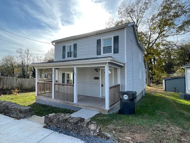 a view of a house with backyard porch and furniture