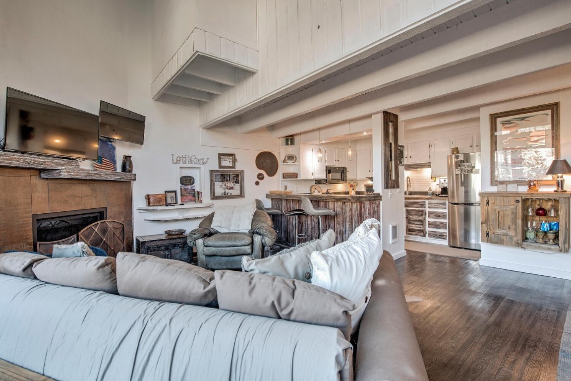 78 Guller Road, Unit 201 Copper Mountain, CO 80443 - Photo 11 of 41 a living room with furniture flat screen tv and a fireplace