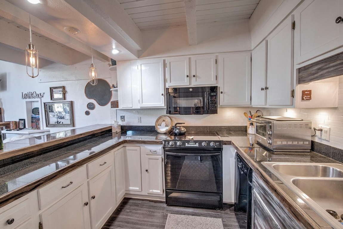 78 Guller Road, Unit 201 Copper Mountain, CO 80443 - Photo 14 of 41 a kitchen with granite countertop a sink stove and cabinets